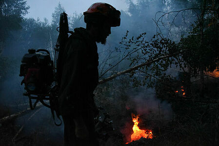 Peat bogs. Firefighters scout and find peat burning underground