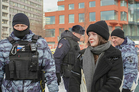 A girl and riot police at a rally in memory of Alexei Navalny, Moscow