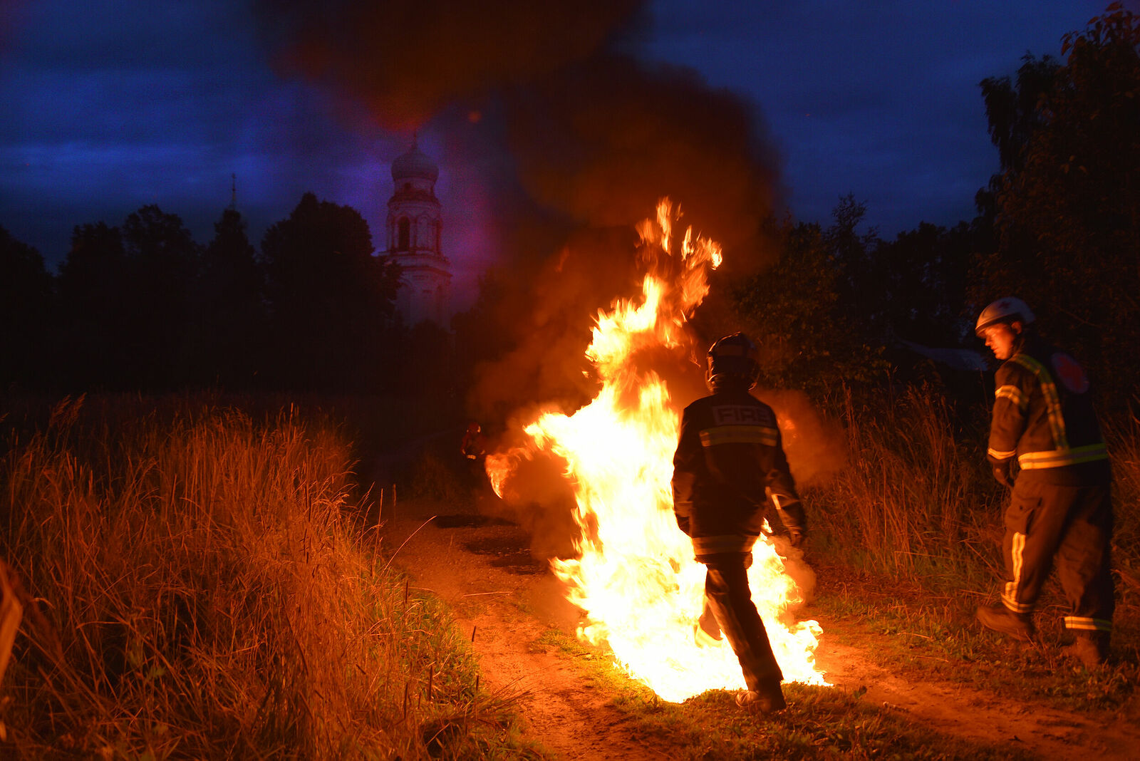 Photojournalist Anastasia Tsitsinova. Reportage. Untitled Girl firefighter goes into the fire at the exercise of the Volunteer forest firefighters