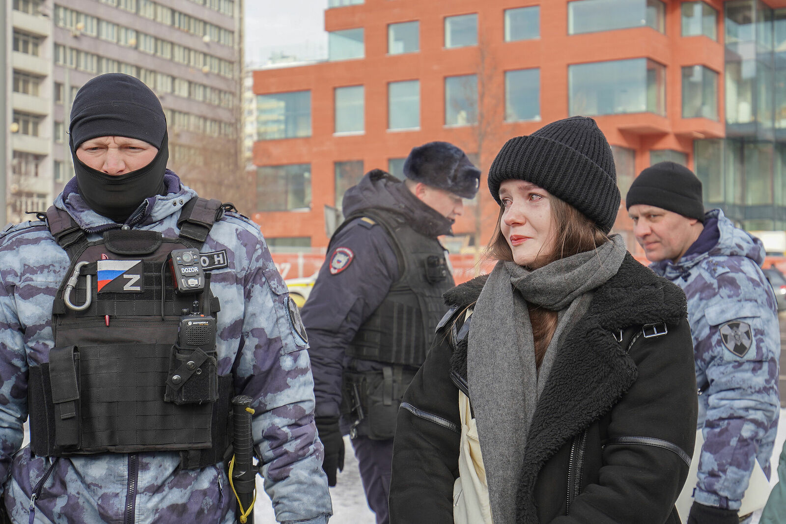 Photojournalist Anastasia Tsitsinova. Portraits. Untitled A girl and riot police at a rally in memory of Alexei Navalny, Moscow